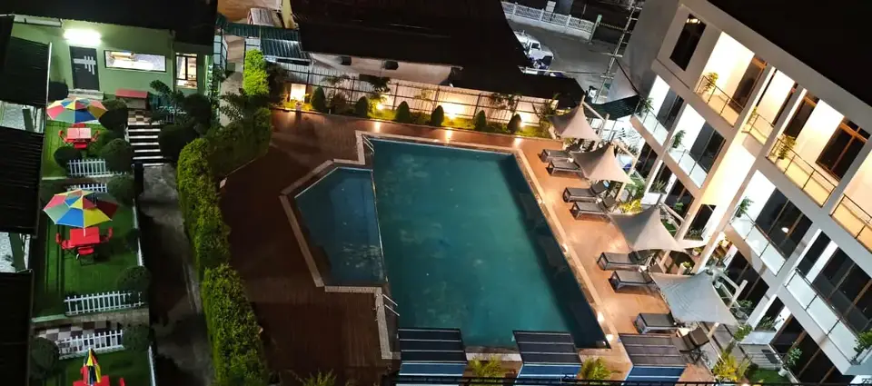 Aerial view of the pool and rooms at night