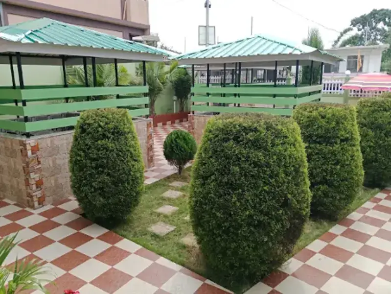 Green-roofed garden cottages and hedges